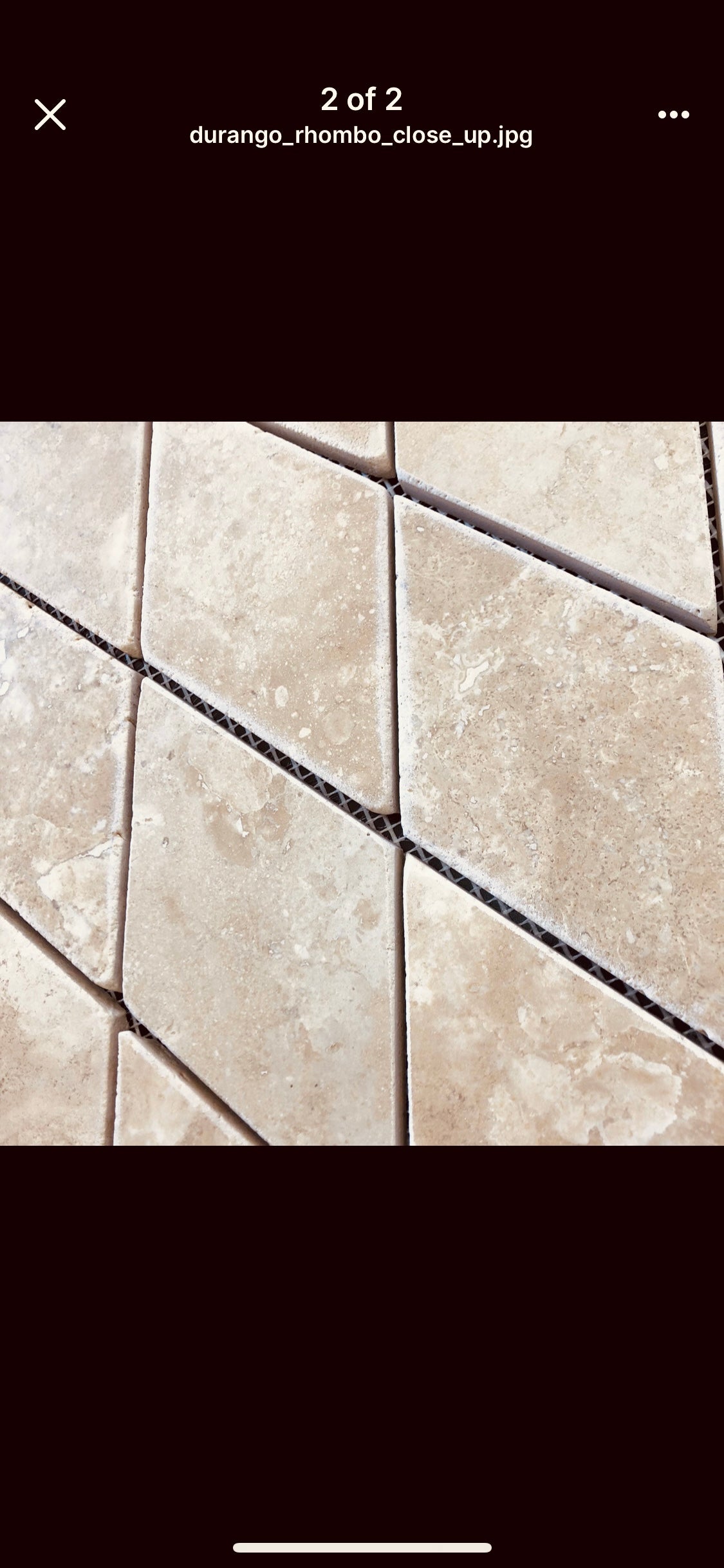Close-up of rhomboid travertine showing tumbled finish and warm tones
