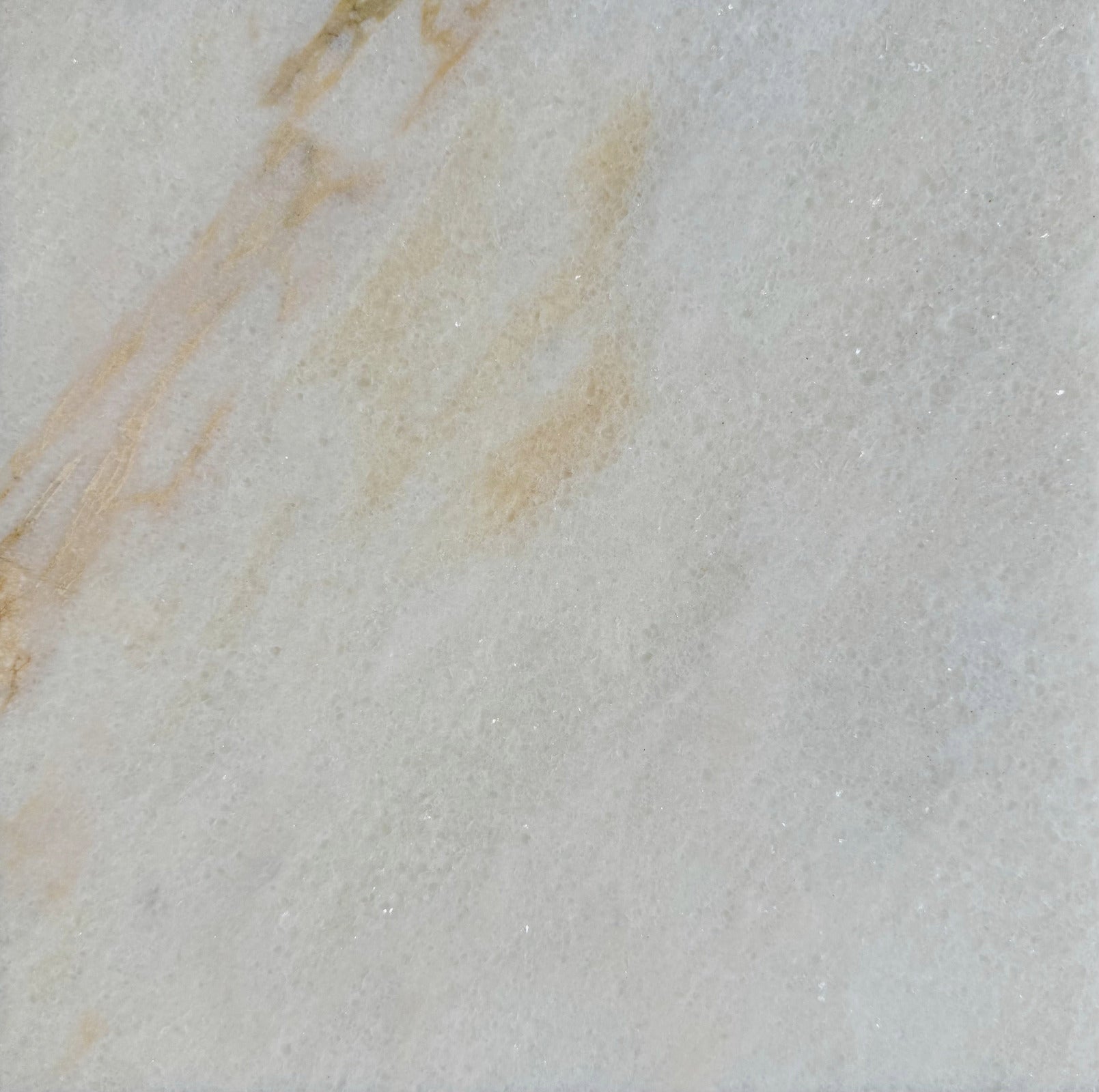 Sample swatch of Giallo Crystal marble tile, cut from actual lot