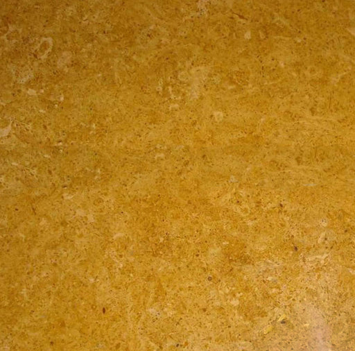 Close-up of Inca Gold Marble 18x18 tile showing warm golden veining on polished surface