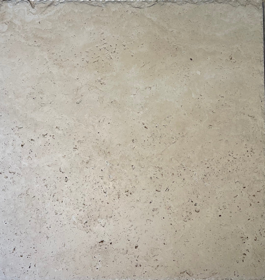Flat view of Ivory Travertine 18x18 Chiseled and Brushed Tile in cream and beige tones