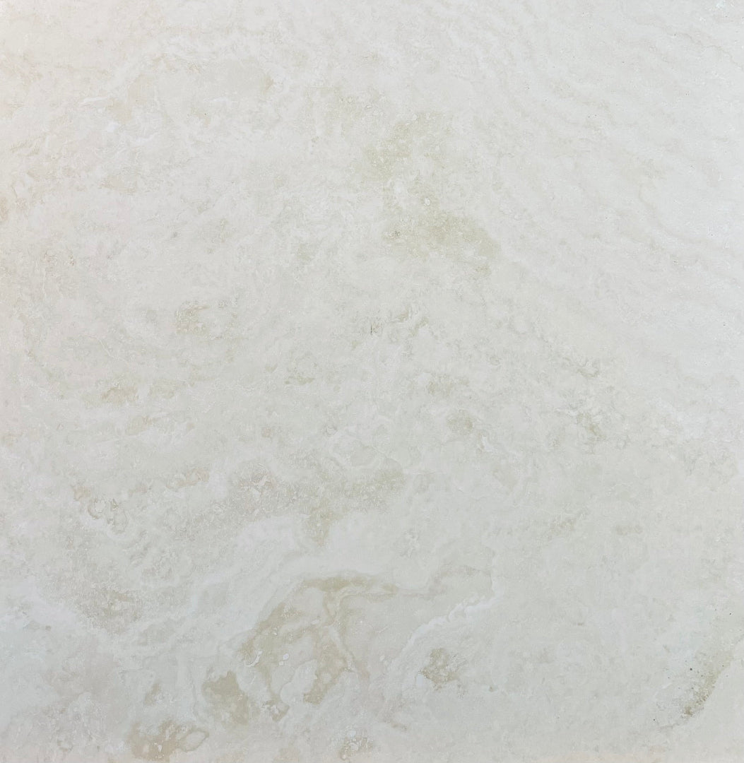 Close-up of Ivory Travertine 18x18 tile showing honed surface and natural variation
