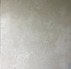 Flat view of Ivory Travertine 18x18 Tumbled Tile with softened edges and warm tones
