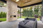 Roman Beige XL Travertine Panels installed on fireplace wall with textured elegance