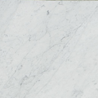 Close-up of Carrara White Marble tile showing soft gray veining on white background
