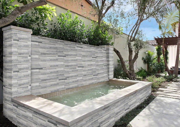Close-up of Alaska Gray 3D Honed stacked stone panel showing marble texture and white veining