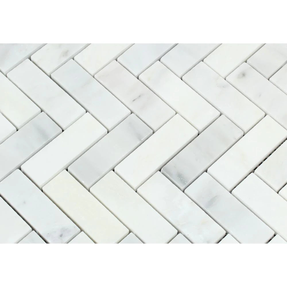 Close-up of 1x3 herringbone mosaic showing Carrara white marble veining