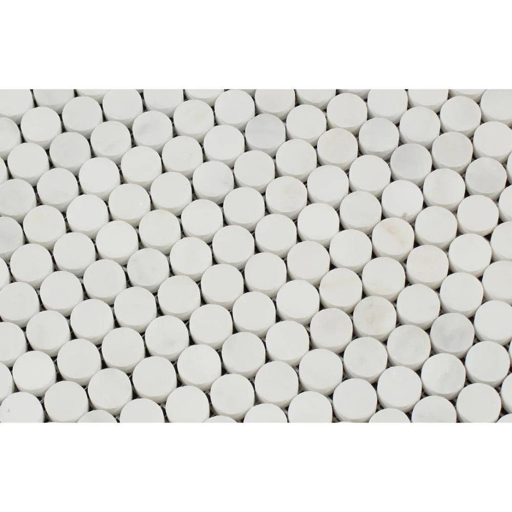Close-up of Arabescato Carrara penny round marble tile showing natural veining