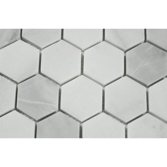 Close-up of Bianco Mare marble showing 2x2 hexagon pattern and natural veining