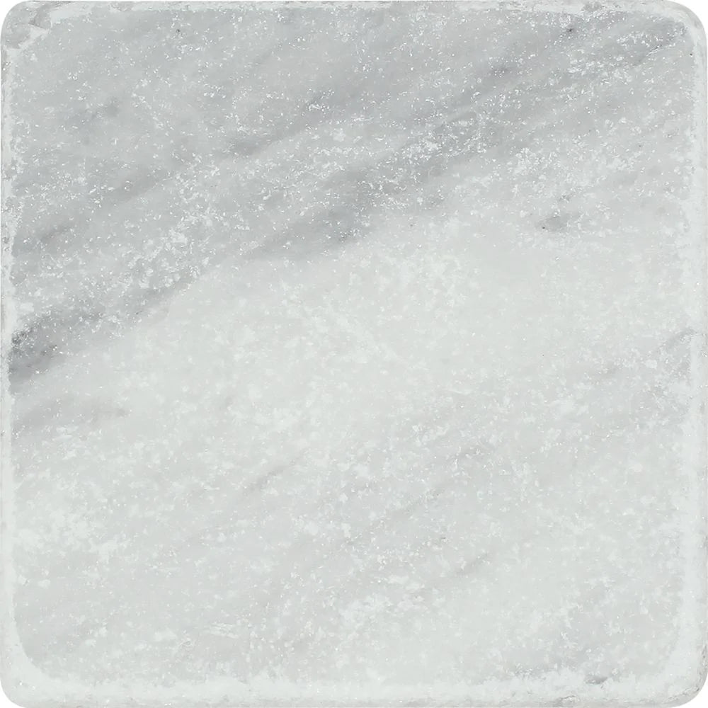Close-up of Bianco Mare Marble Tile showing tumbled texture and gray veining