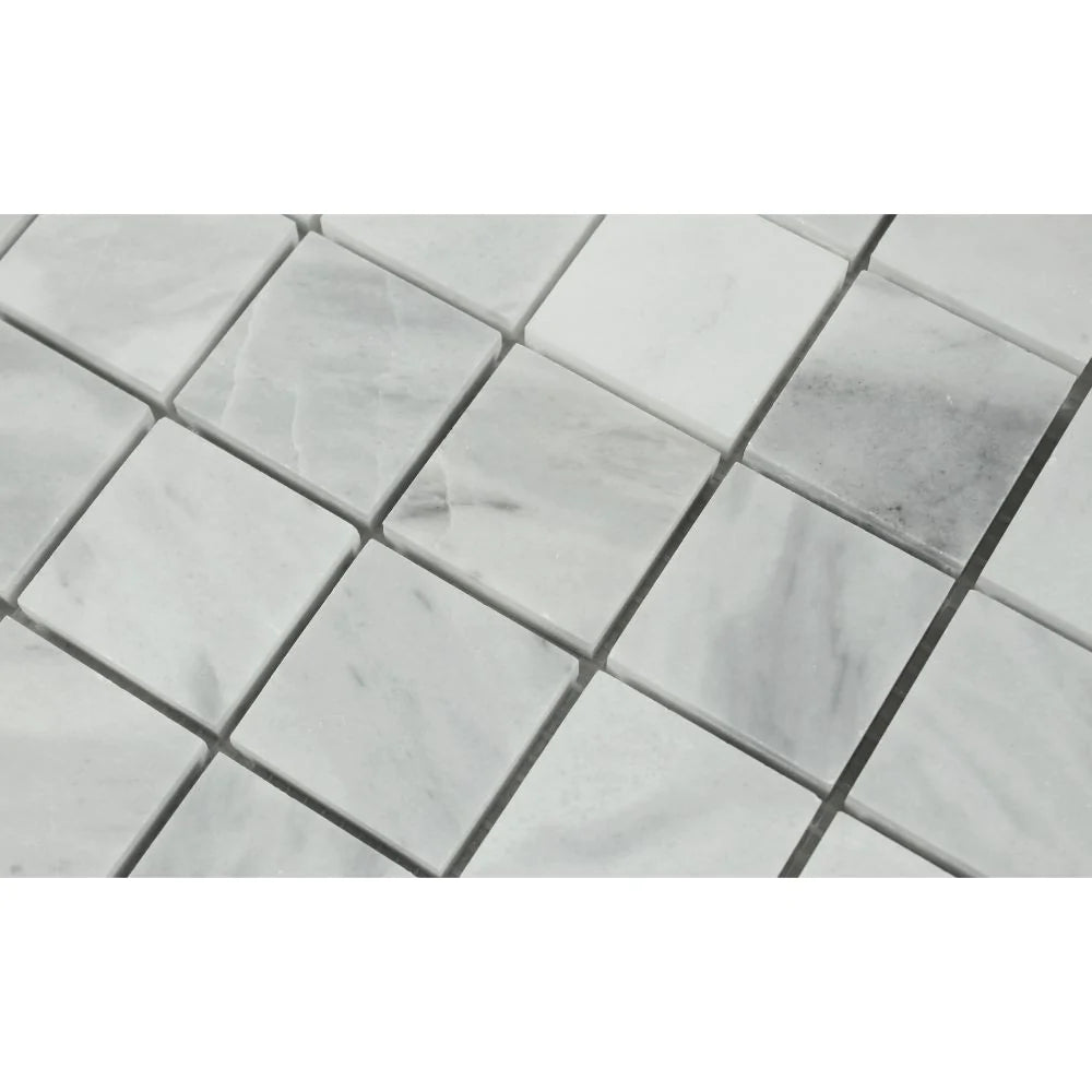 Close-up of Bianco Mare 2x2 mosaic showing polished marble texture and veining
