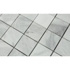 Close-up of Bianco Mare 2x2 mosaic showing polished marble texture and veining