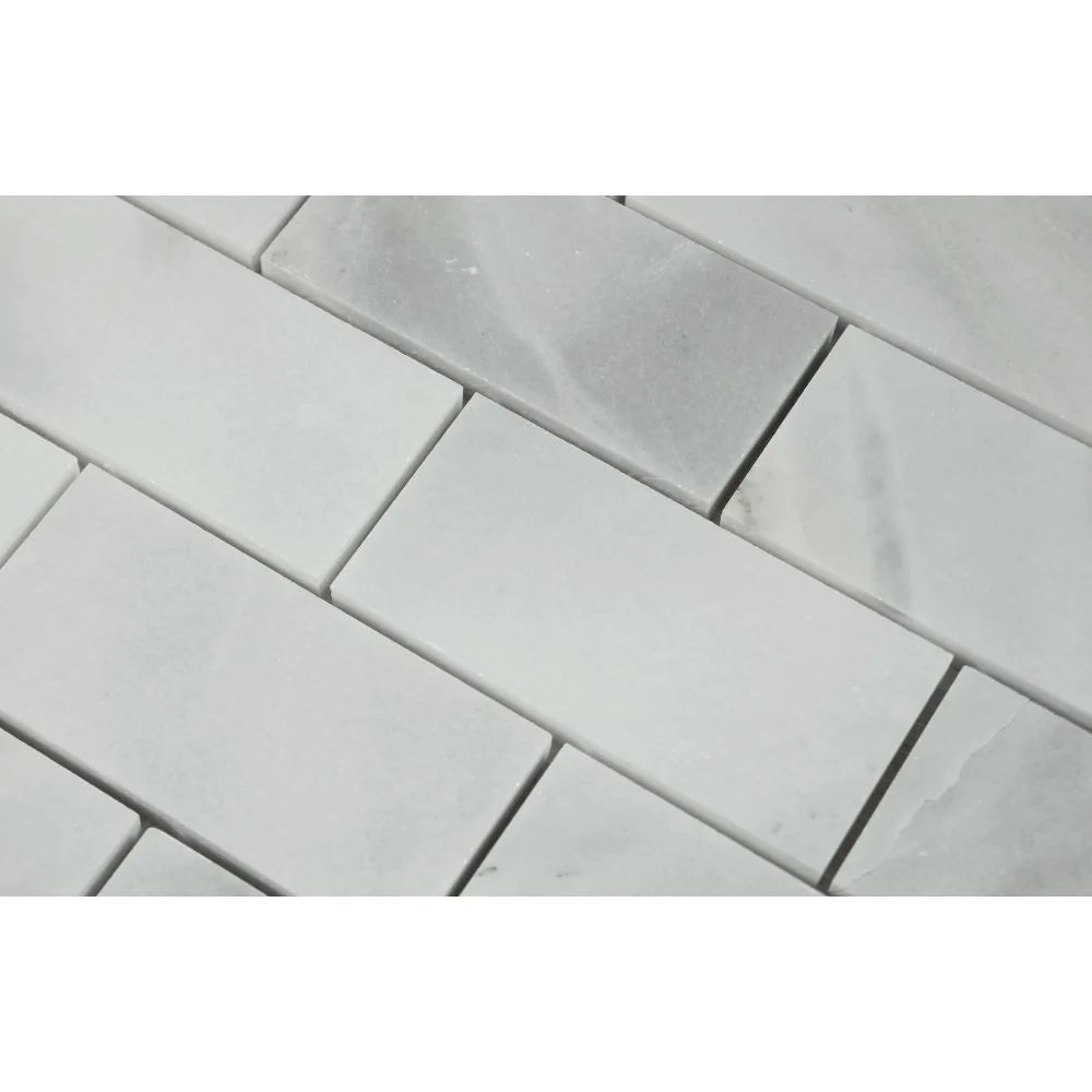 Close-up of Bianco Mare 2x4 marble mosaic showing polished texture and natural veining