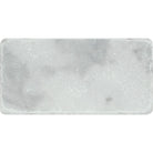 Close-up of Bianco Mare marble tile showing soft veining and tumbled edges