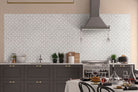 Close-up detail of Bianco Starlight mosaic showing waterjet-cut star design in polished marble