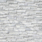 Flat lay of Calacatta Cressa 3D marble panel with soft white and gray tones