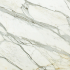 Close-up of Calacatta Gold Marble showing rich gold veining on white background