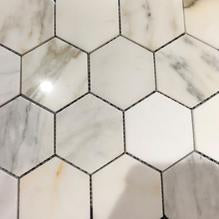 Sample piece of Calacatta Gold 3-inch hexagon marble tile, cut from actual lot