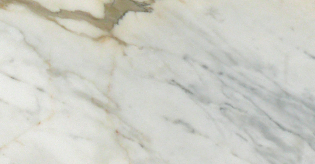 Close-up of Calacatta Gold 6x12 marble tile showing bold veining