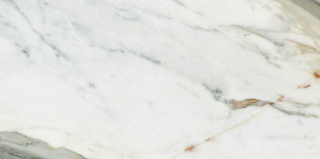 Close-up of Calacatta Gold 6x12 marble tile showing bold veining