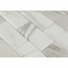 Close-up of Calacatta Gold marble showing deep beveled edge and gold veining
