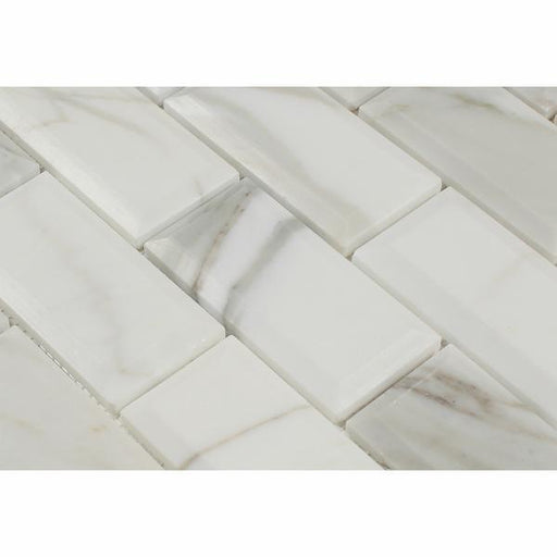 Close-up of Calacatta Gold marble showing deep beveled edge and gold veining