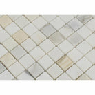 Close-up of Calacatta Gold 1x1 tile showing detailed veining and finish