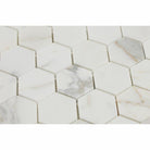 Close-up of Calacatta Gold 2" hexagon tile showing detailed veining

