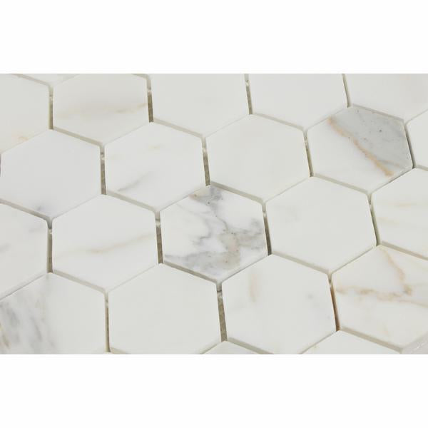 Close-up of Calacatta Gold 2" hexagon tile showing detailed veining

