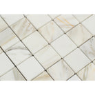 Close-up of Calacatta Gold 2x2 mosaic tile showing veining and surface texture