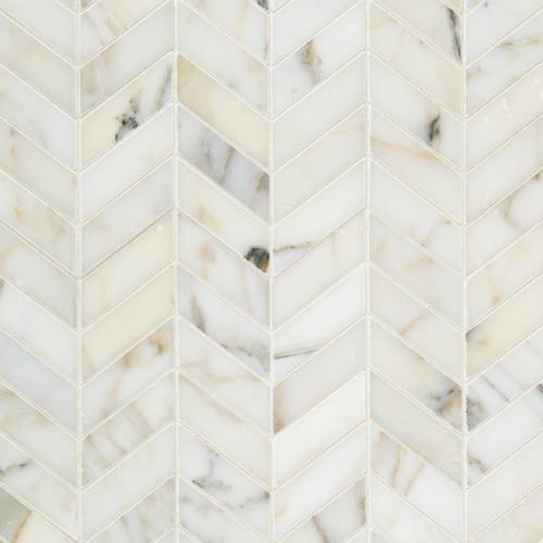 Close-up of Calacatta Gold marble in chevron layout with gold and gray veining
