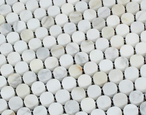 Close-up of Calacatta Gold marble penny rounds showing golden veining