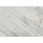 Close-up of Calacatta Gold strip mosaic showing linear pattern and gold veining