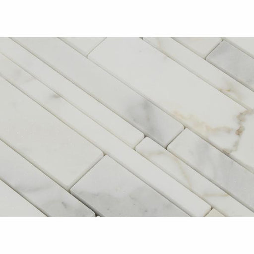 Close-up of Calacatta Gold strip mosaic showing linear pattern and gold veining