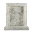 Close-up of Calacatta Gold veining detail on shampoo niche edge
