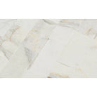 Close-up showing chiseled texture and golden veining of Calacatta Gold Splitface Marble