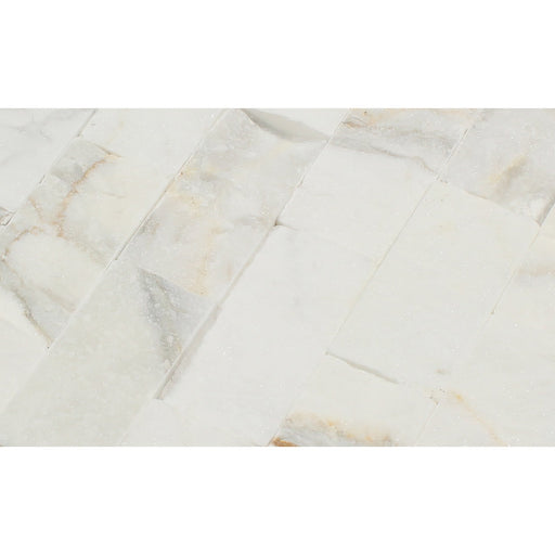 Close-up showing chiseled texture and golden veining of Calacatta Gold Splitface Marble