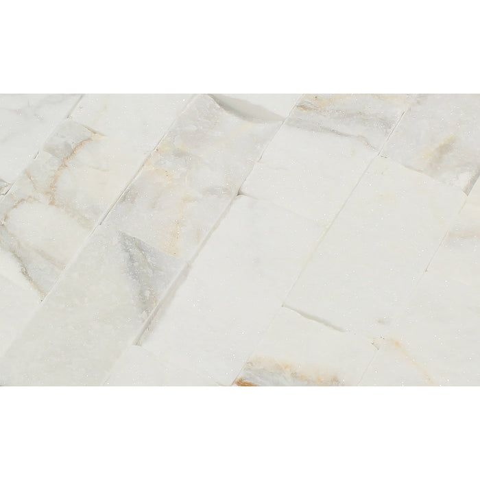 Close-up showing chiseled texture and golden veining of Calacatta Gold Splitface Marble