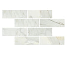 Close-up of Calacatta Gold 4x12 marble tile highlighting veining and polished surface