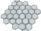 Detail of Carrara marble hex tiles with polished blue glass inserts