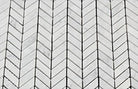 Close-up of Carrara mini chevron marble mosaic pattern