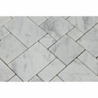 Close-up view of Carrara White marble mosaic showing soft gray veining