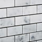 Close-up of Carrara White Marble Mosaic in brick layout showing polished surface and veining