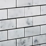 Close-up of Carrara White Marble Mosaic in brick layout showing polished surface and veining