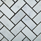 Close-up of Carrara White Herringbone Mosaic 1x2" showing detailed veining and smooth marble texture