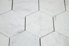 Close-up of Carrara White hex tile showing gray veining and polished surface