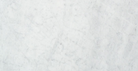 Close-up of Carrara White Marble 6x12 subway tile with soft gray veining on white background