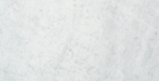 Close-up of Carrara White Marble 6x12 subway tile with soft gray veining on white background