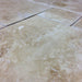 Close-up of Crema Ivory Travertine showing chiseled edge and soft textured surface