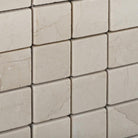 Close-up of Crema Marfil 2x2 mosaic with tumbled marble texture