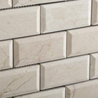 Close-up of Crema Marfil 2x4 mosaic showing bevelled polished edge